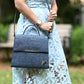 A woman is holding Zenkindstore's Chic City Bag