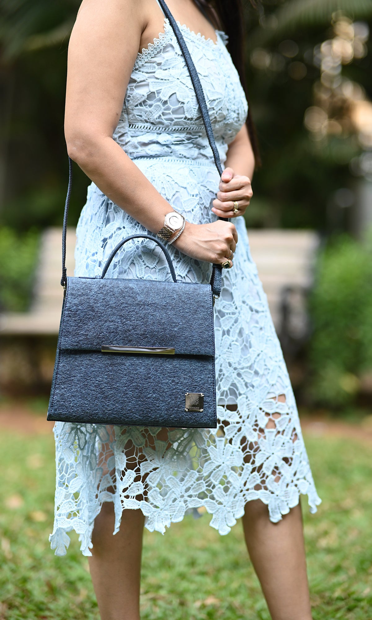 A woman is holding Zenkindstore's Chic City Bag