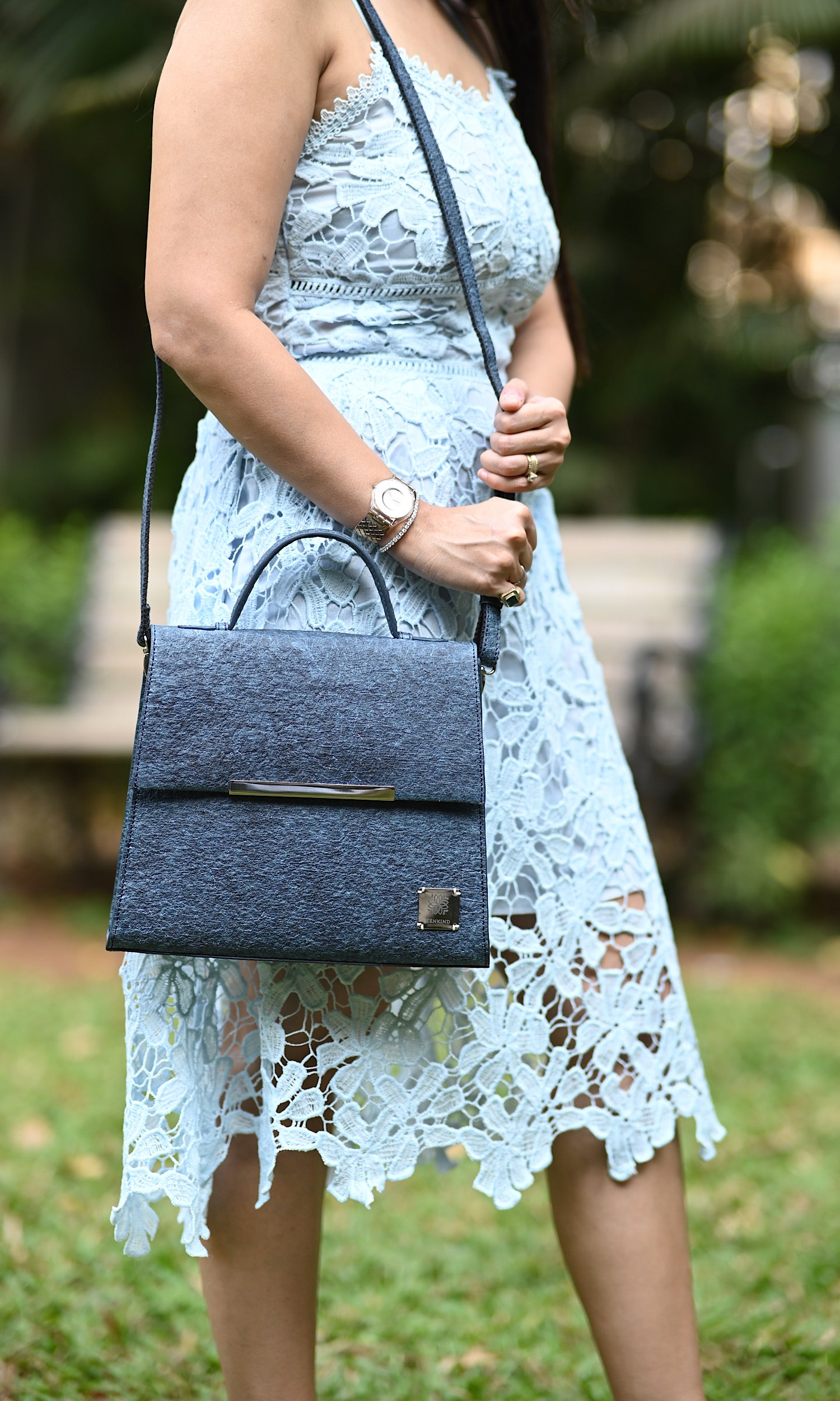 A woman is holding Zenkindstore's Chic City Bag