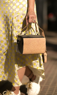 A woman is holding Zenkindstore's Mini Natural Duffle Bag