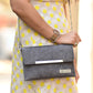 A woman is holding Zenkindstore's Envelope Sling Bag